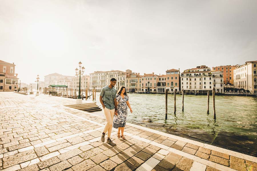 Couple walking through empty alley in Venice during sunrise, photographed by a local Venice photographer