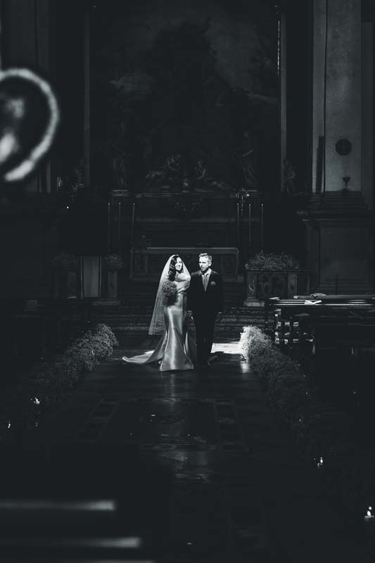 The couple walking through the luxurious hall of the Hotel Monaco, Venice.