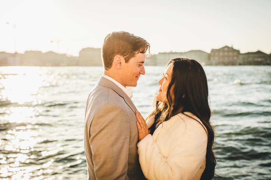 engagement couple walking in Venice near a quiet canal at sunset
