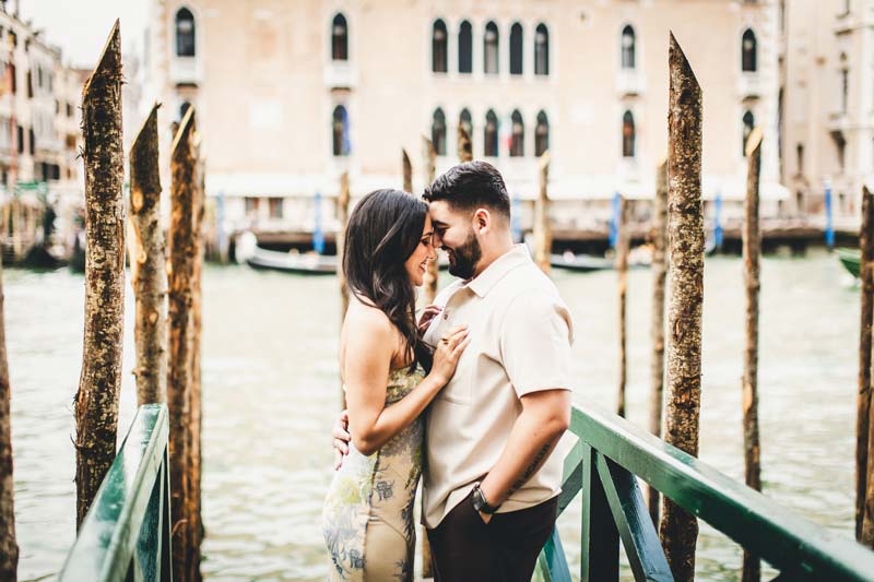 Newly engaged couple walking hand in hand in Dorsoduro at sunrise.