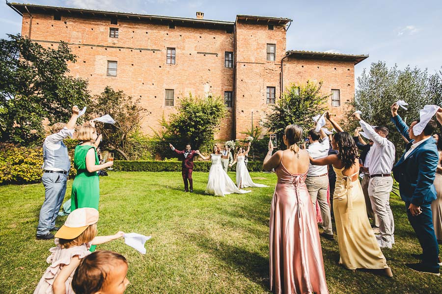 Candid wedding photography Tuscany capturing guests interacting during cocktail hour