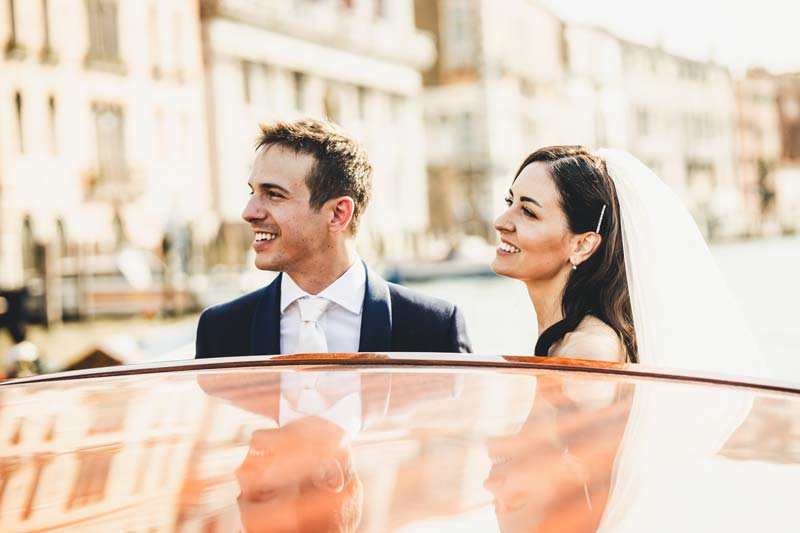 Dynamic photo of the couple on a taxi ride on the Grand Canal.