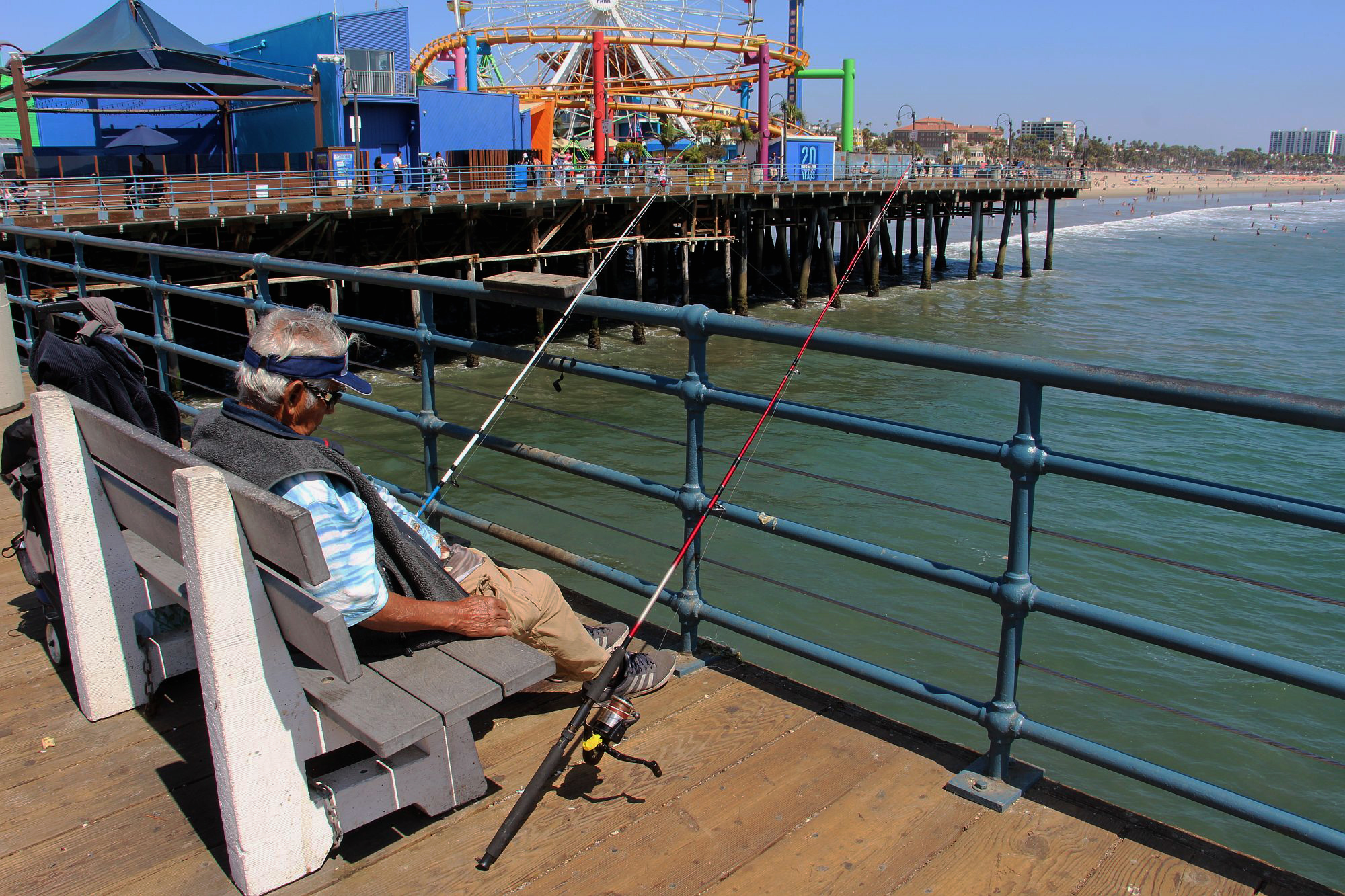 Sleeping fisherman on the pier at the Pacific Park