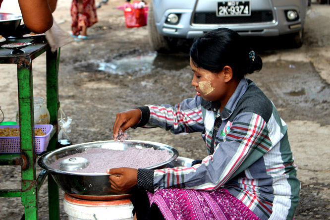 Woman cooking streetfood in Myanmar