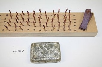 Cribbage-style board used to dry matches after consolidation of the phosphorous.