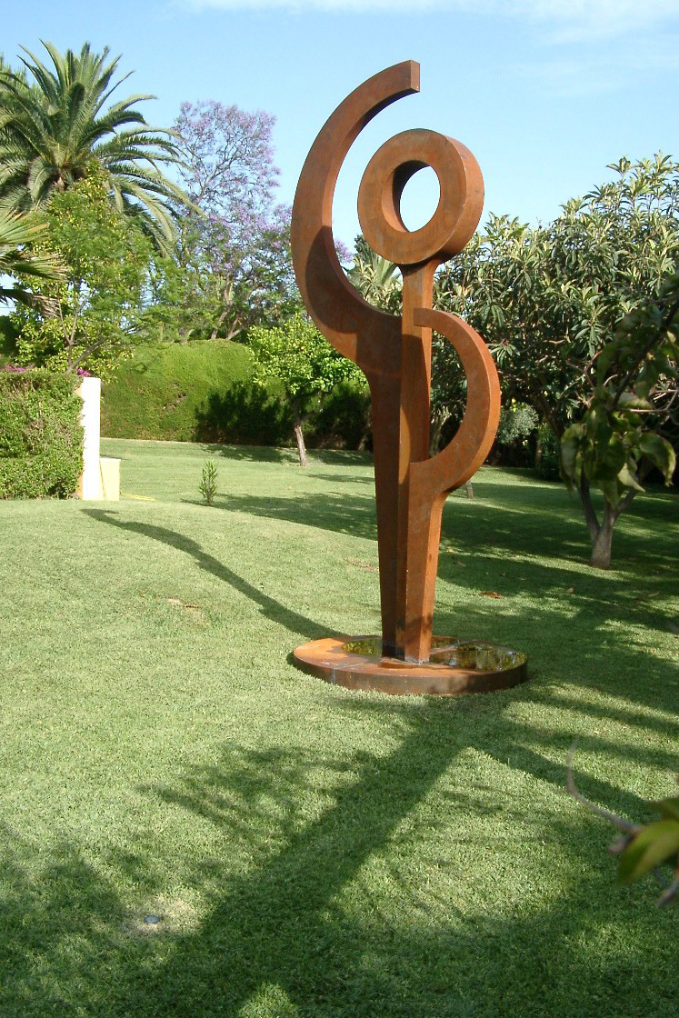 This abstract sculpture by HEX resides over a garden in Marbella.