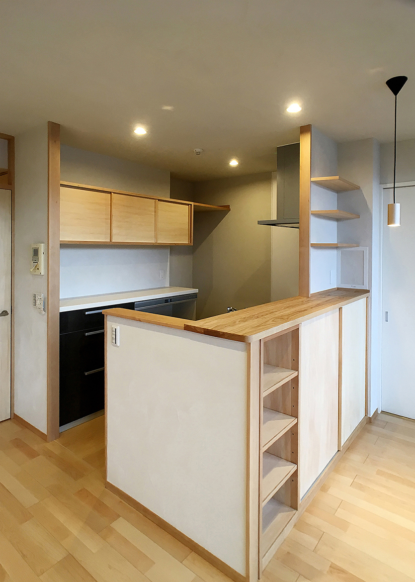 セミオープンキッチン。背面には取り出しやすい高さの吊戸棚を設置。