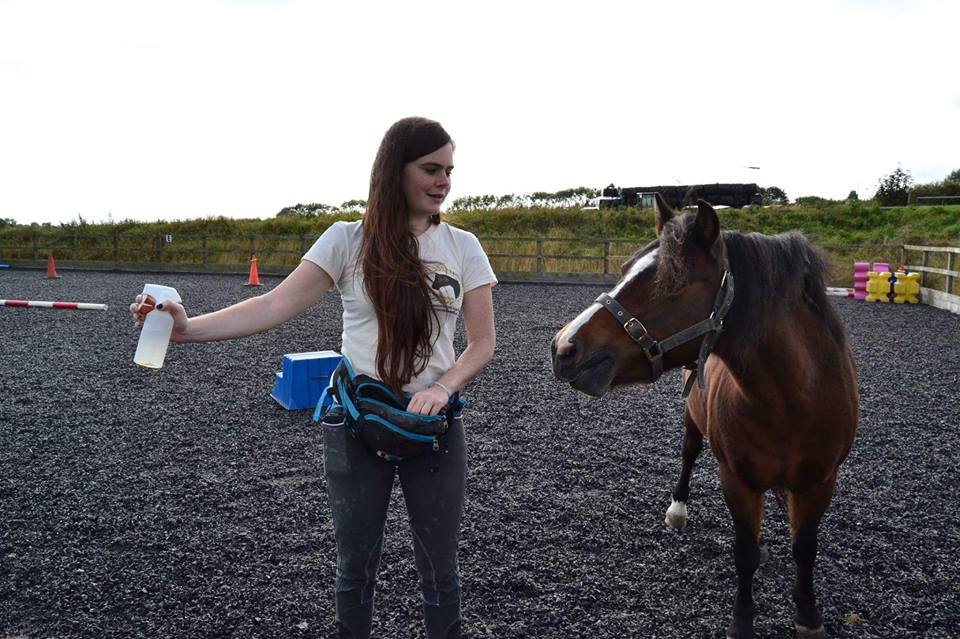 Jane from East Devon Riding School learning that fly spray are not scarry. (Photo by Millie Moore)