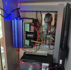 Panel with modem, battery and cabling.