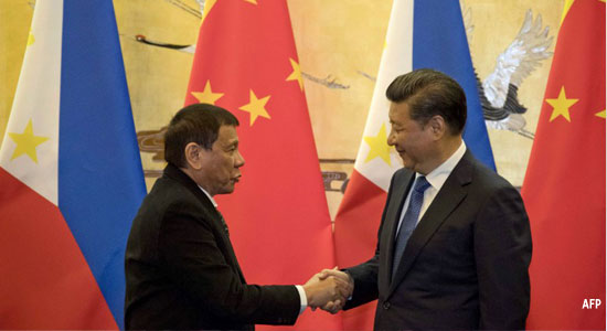 President Rodrigo Duterte (L) and his Chinese counterpart Xi Jinping shake hands after a signing ceremony in Beijing on October 20, 2016. AFP
