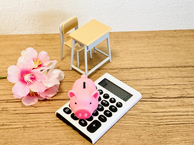 電卓と貯金箱 看護学校の学費比較と合格後の生涯賃金イメージ