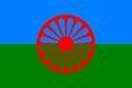 The blue and green of the Roma flag represent heaven and earth. The red wheel represents the itinerant tradition of the Romani people.