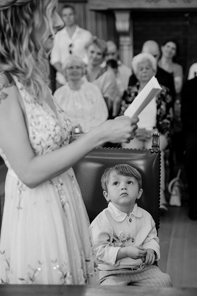 kleuterjongen zit gebiologeerd naar de bruid te luisteren-huwelijksfotografie-trouwreportage-byFotografils-IlseWagemakers-Fotograaf gevestigd in Essen