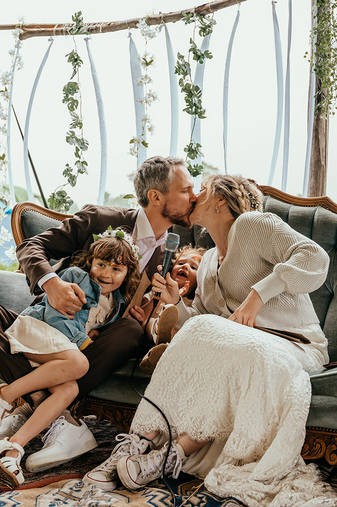 bruid en bruidegom kussen tijdens hun ceremonie, hun kindjes zitten erbij-huwelijksfotografie-trouwreportage-byFotografils-IlseWagemakers-Fotograaf gevestigd in Essen