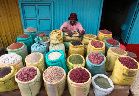 A woman prepares grains at her shop in the Kibera slum in the Kenyan capital of Nairobi, Jan. 20, 2012. Kibera is a vast shanty town that lacks even basic services such as sanitation. Many residents are angry that while prices of food have risen, wages ha