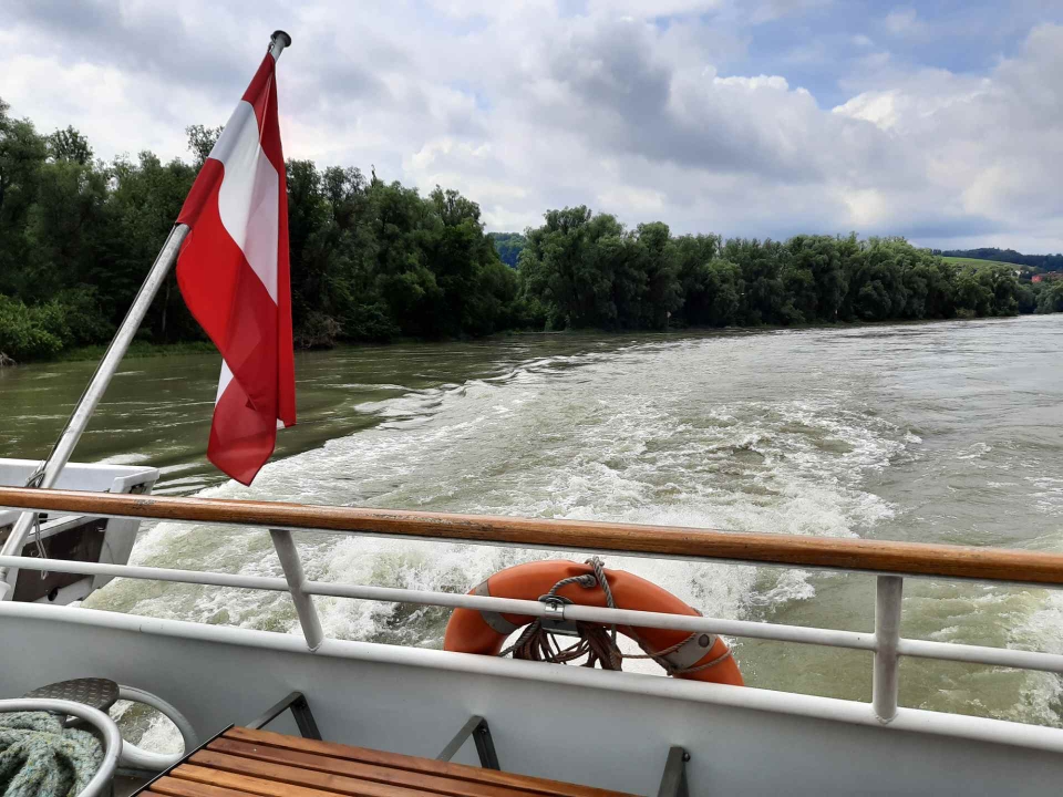 Die österreichische Flagge weht am Heck des Schiffes über dem Kielwasser
