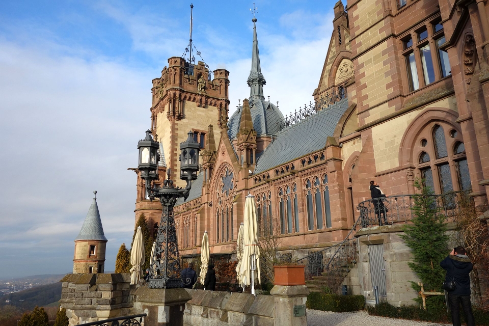 Blick auf die prunkvolle Seitenfassade von Schloss Drachenburg unter blauem Himmel