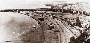 Les Fusiliers Mont Royal vont débarquer au centre de la plage parmi les LCT et les tanks. On aperçoit à droite le casino. Au fond à droite la falaise d'où tirait la batterie "Bismark"