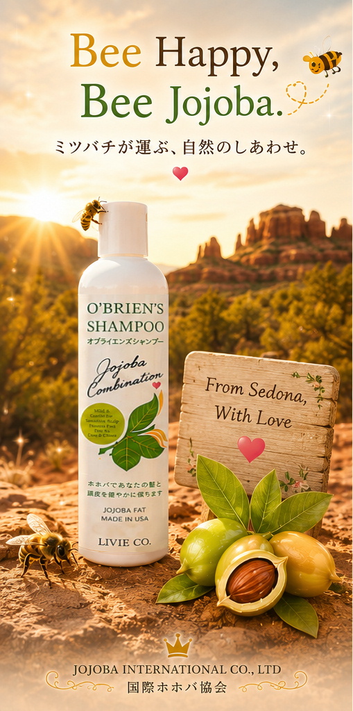 セドナの自然を背景に、原種ホホバの花とミツバチ、O'Brien's Shampoo を配した国際ホホバ協会の「LAUGH AND BEE JOJOBA FAT」ビジュアル。「笑う門には福来る」をテーマに、自然とホホバ、ミツバチの共生を表現したイメージ。