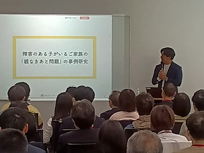 講師がプロジェクターに映したスライドで説明はじめる様子の写真