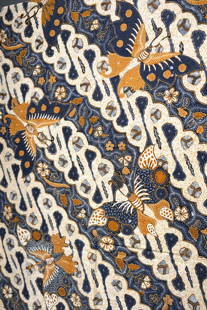photo of indonesian batik cloth in blue, white, orange pattern