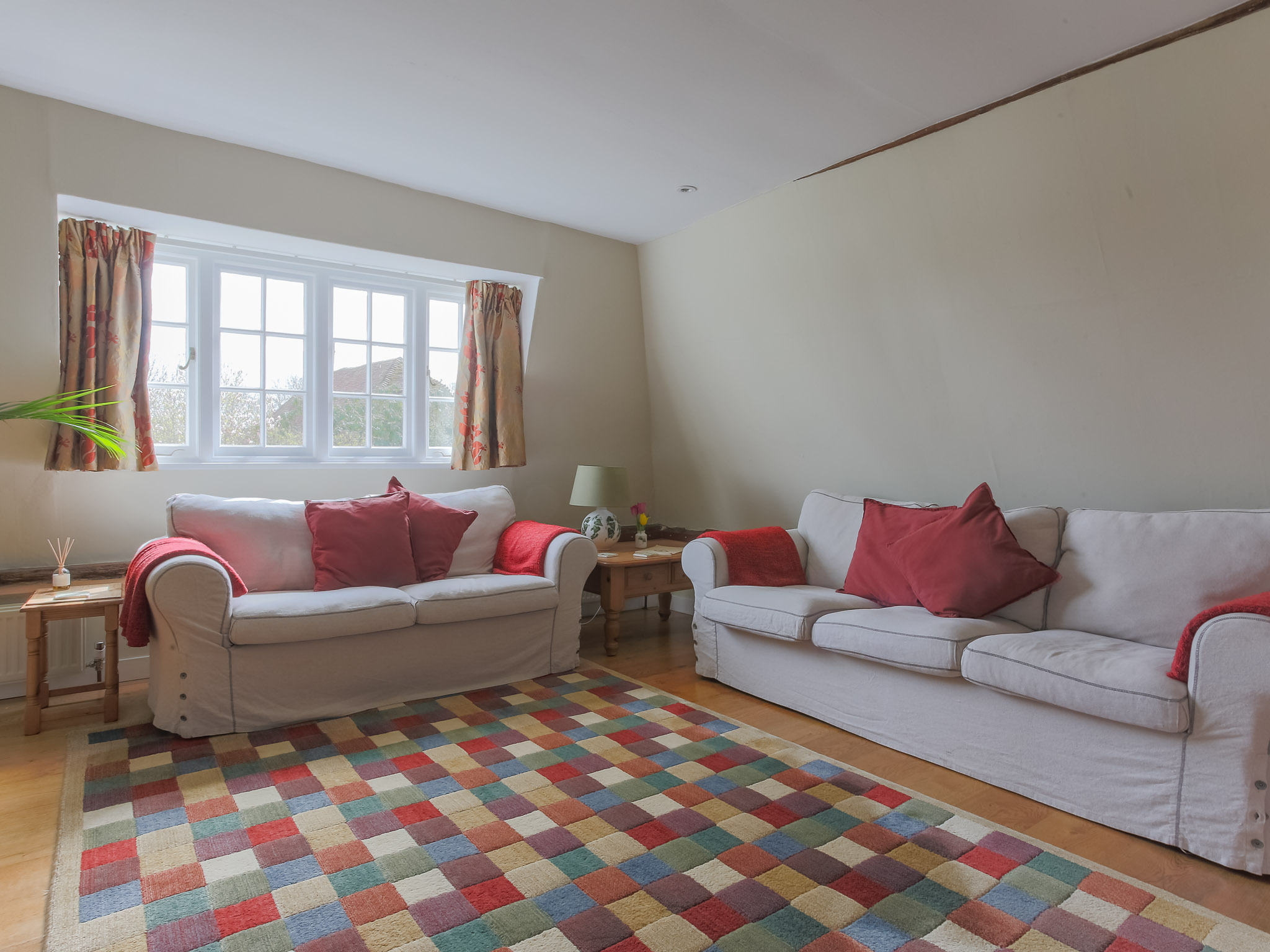 The sitting room is comfortably furnished and spacious