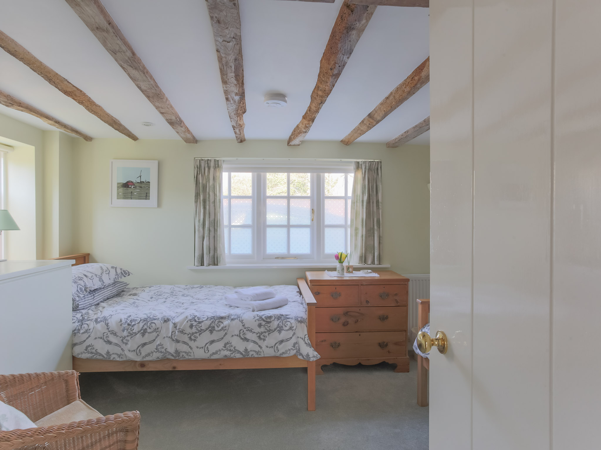 The twin bedroom with exposed beams but plenty of headroom