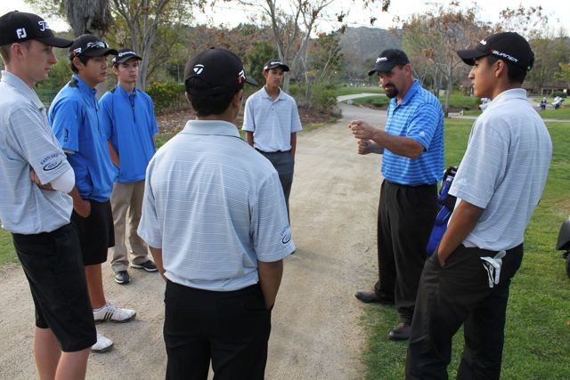 Coach Barrett conducts his post-round review and congratulates players on their win