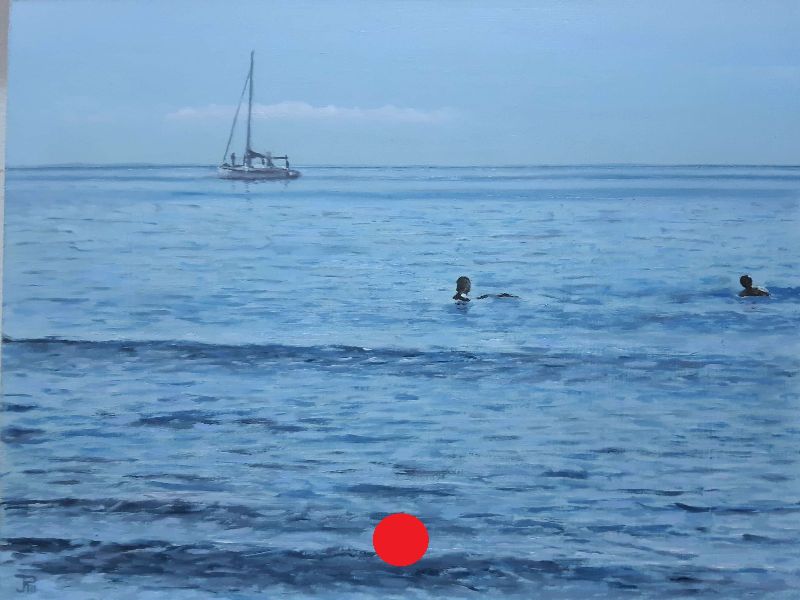 Velero fondeado frente a la playa con mar en calma y dos bañistas en primer plano.