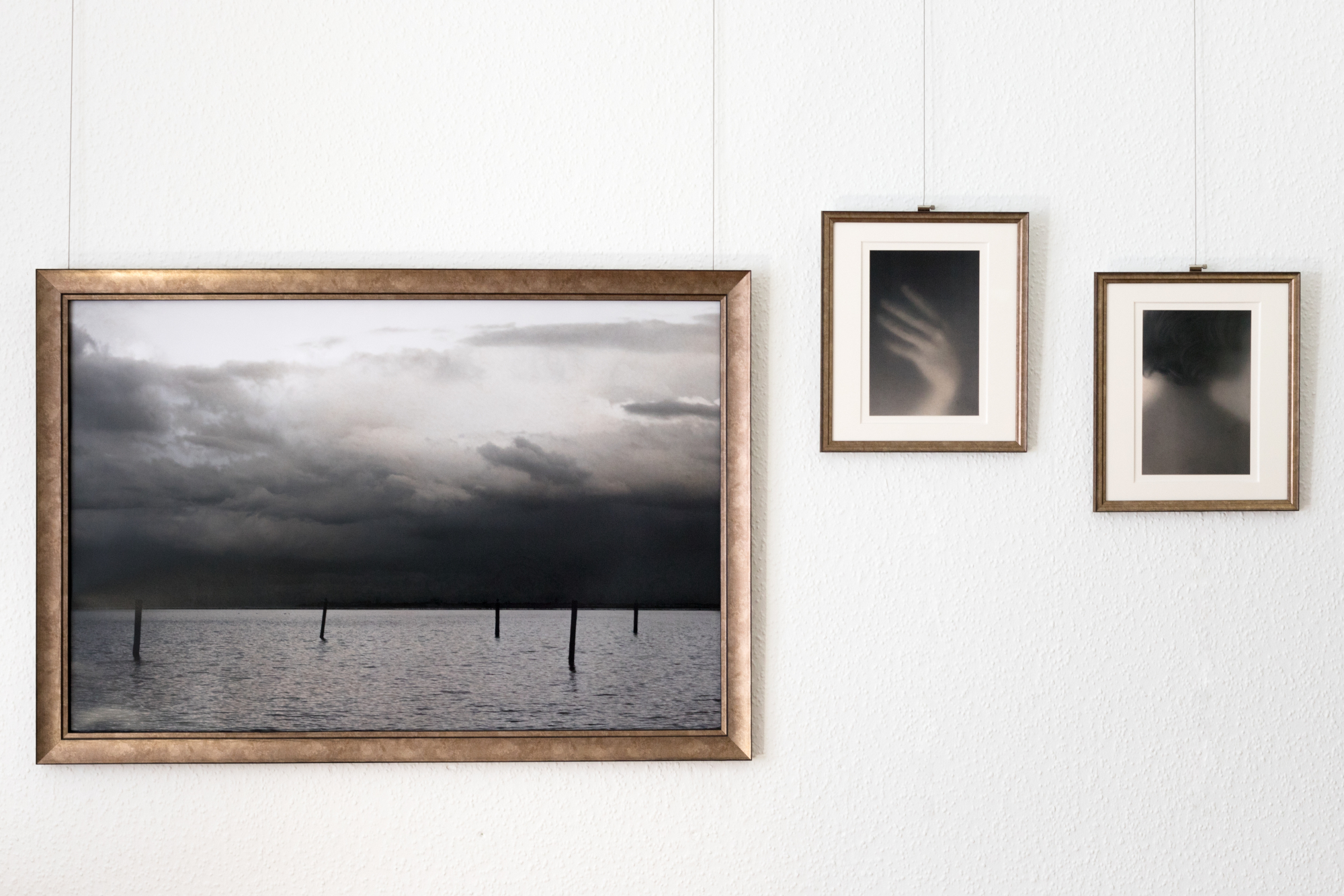 Kirsten Radermacher, am Meer 2016 (976 x 674 mm), Hand 2019 and Selbst #8 2019 (each 286 x 331 mm), hand-colored photograph, framed in museum quality, ed. 3+1AP (each unique)