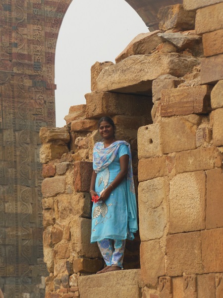 2013 A Woman wearing her holiday finery at Qutub Minar in Delhi