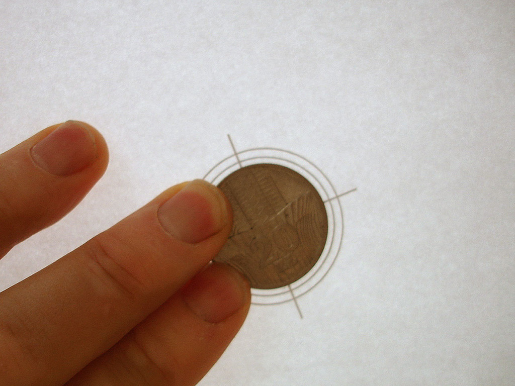 Attach coin to exact centre of template using adhesive tape to sides or, better again, double-sided tape to underside.
