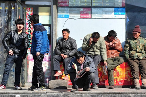 Migrant workers wait outside of a job fair, Xinhua 2/19/2014.