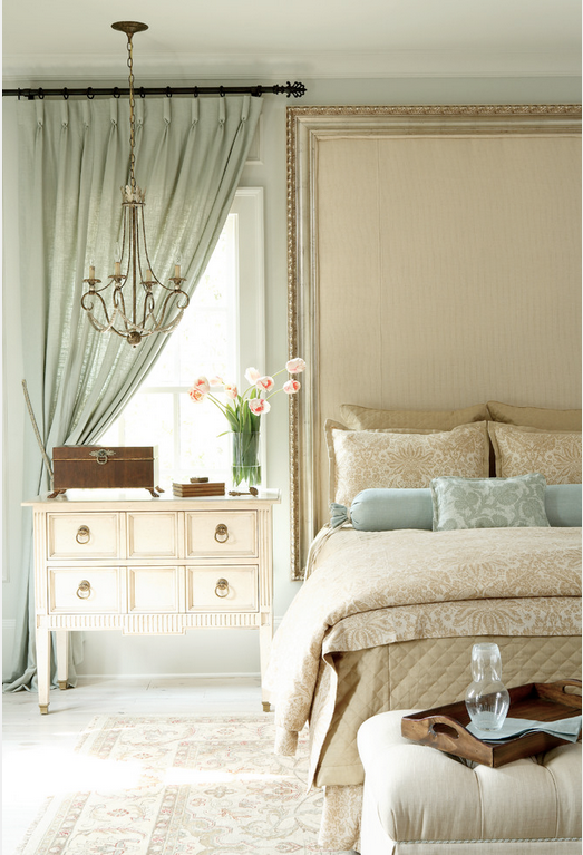 Roll-pleated tied back drapery suits this window beside a bed. Photo Attributed to: J. Hirsch Interior Design, LLC