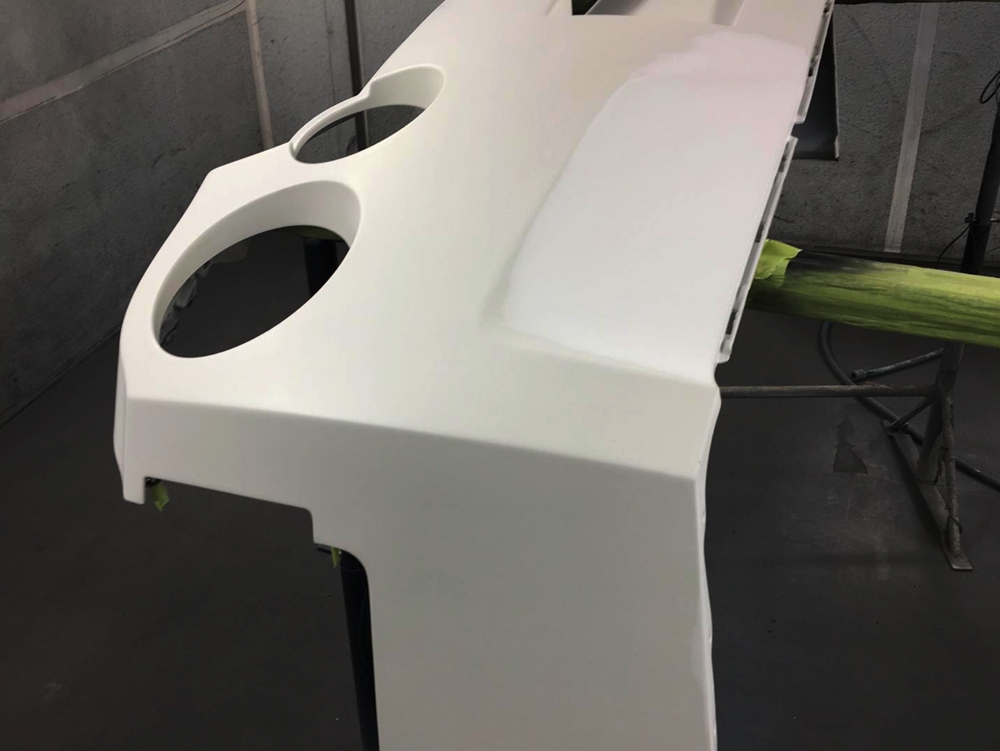 Section of white Nissan GTR LM750 in workshop