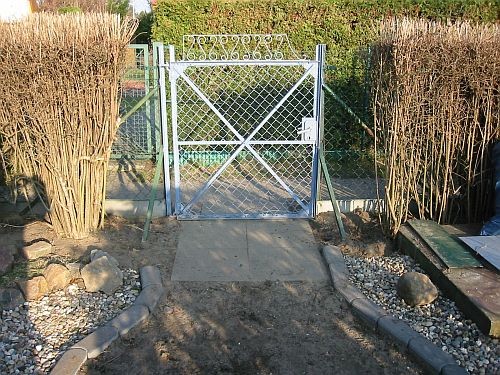 Teile der Hecke wurden weggenommen, dort stehen später die Seitenteile des  Rosenbogen