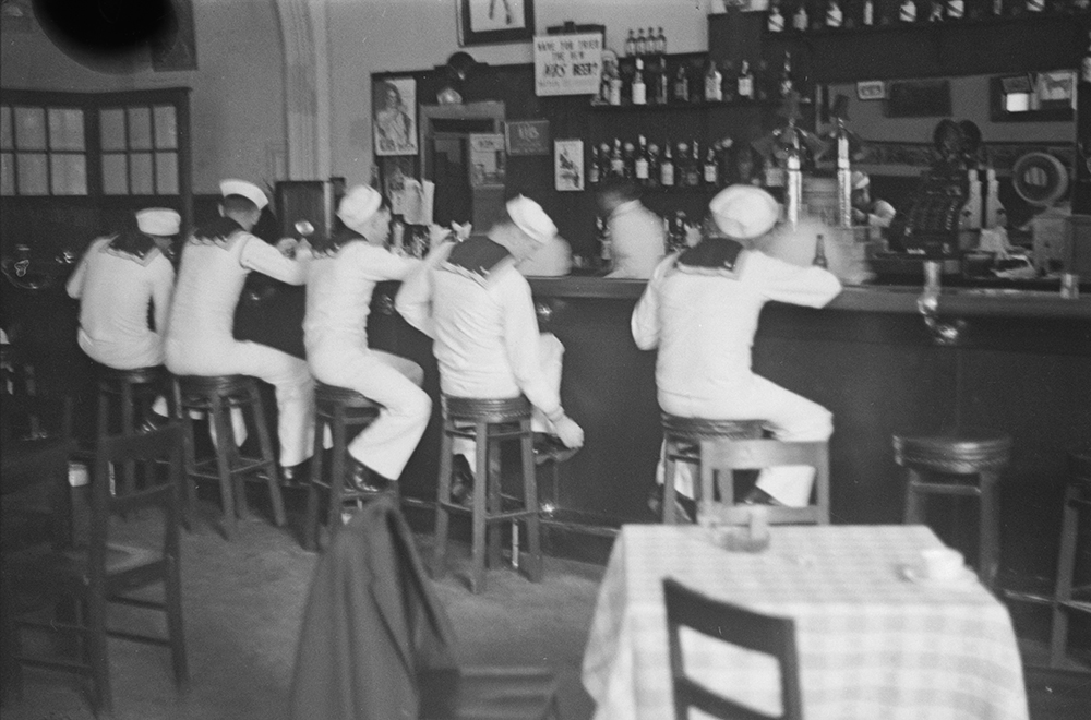 Inside a bar on Blood Alley with an NBS beer sign (and 2 U.B. beer ads) visible behind the counter