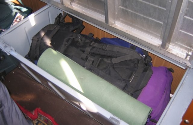 Een grote rugzal past zonder problemen in de gesloten bagagebak onder de bank.