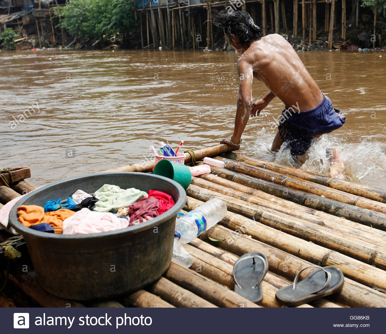 A man living near Ciliwung river takes a bath in the river at a Jakarta slum area (Alamy Stock Photo,  REUTERS , April 20 2012). 