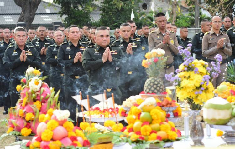 Religious gathering of soldiers in front of offerings and drums.