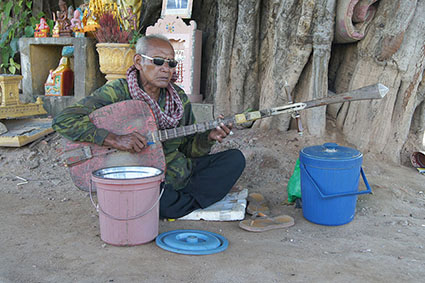 Keo Samnang, blind traditional chapei player in the streets of Phnom Penh in 2011. Keo Samnang, blind traditional chapei player along Tonle Sap river in Phnom Penh, 2011. 