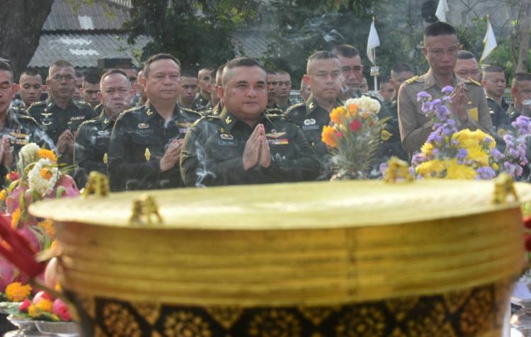 Religious gathering of soldiers in front of bronze drums.