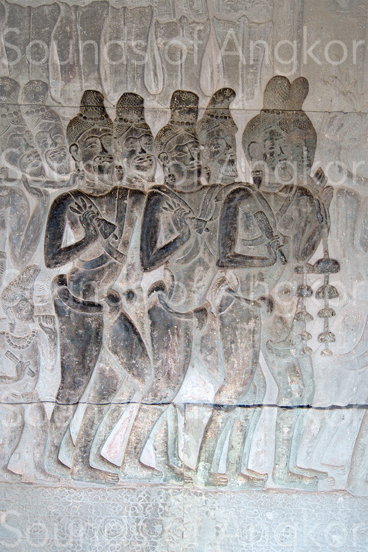 Brahmins waving half-vajra bells and striking bell trees. Angkor Wat, south gallery, west bay.