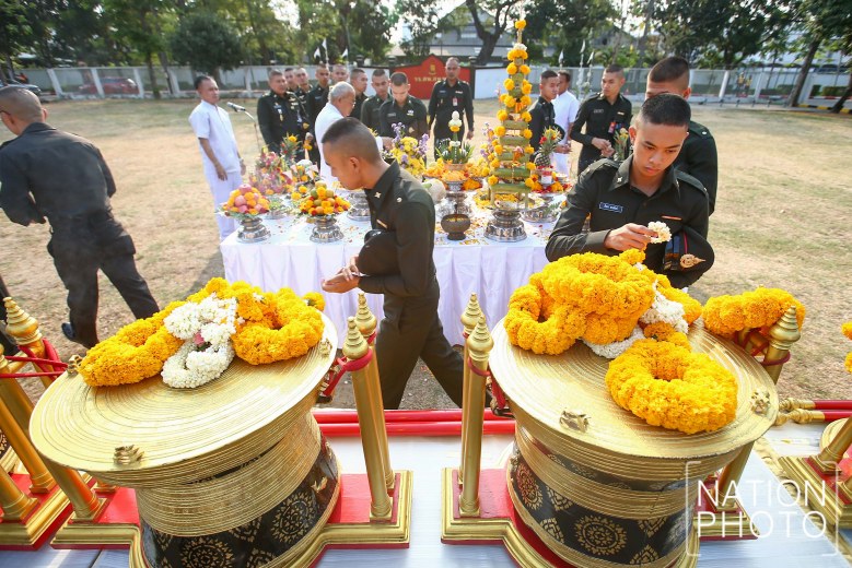 The soldiers place offerings of flowers on the drums.