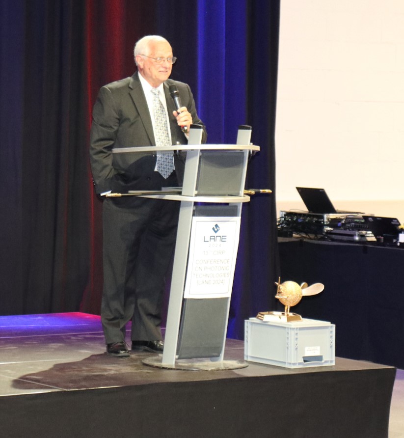 Prof. David Bourell with his trophy the "Golden Dr. Speckle with laser sword" at LANE 2024