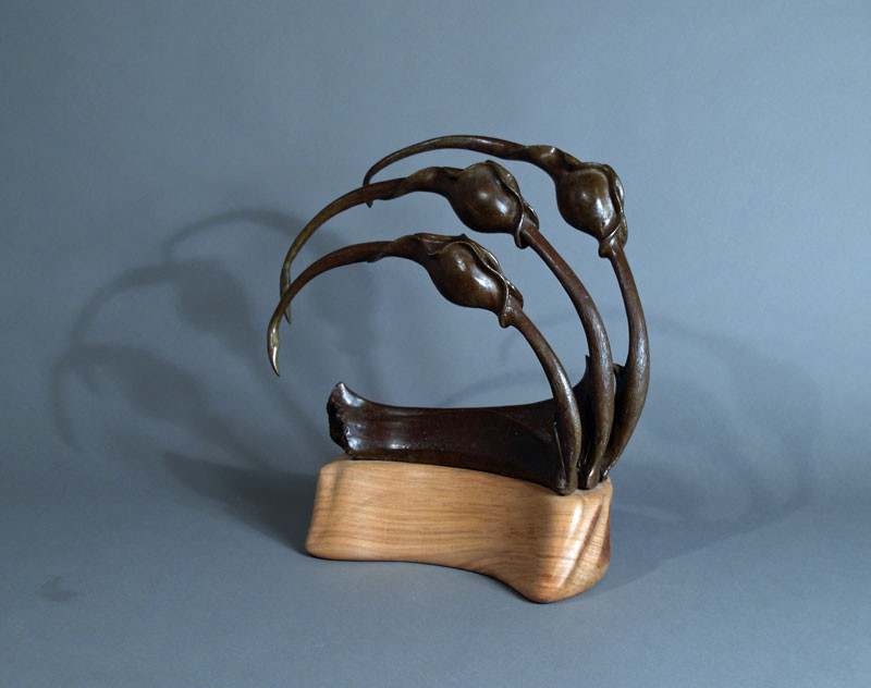 Bronze Sculptural Piece on shaped walnut base.