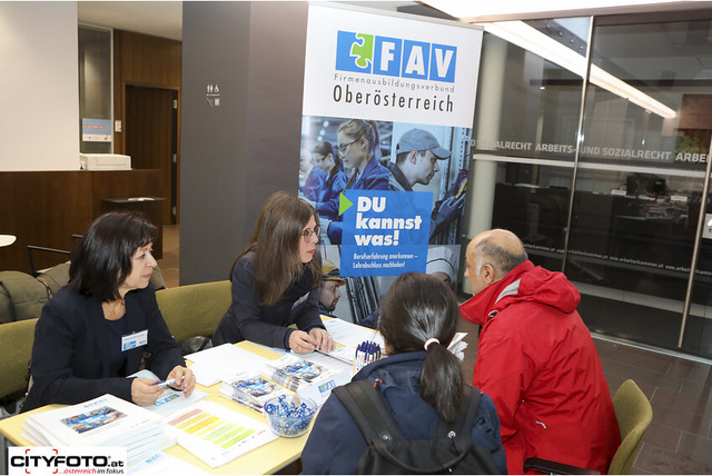 Beratungssituation mit Messebesucher:innen am Infostand von FAV OÖ
