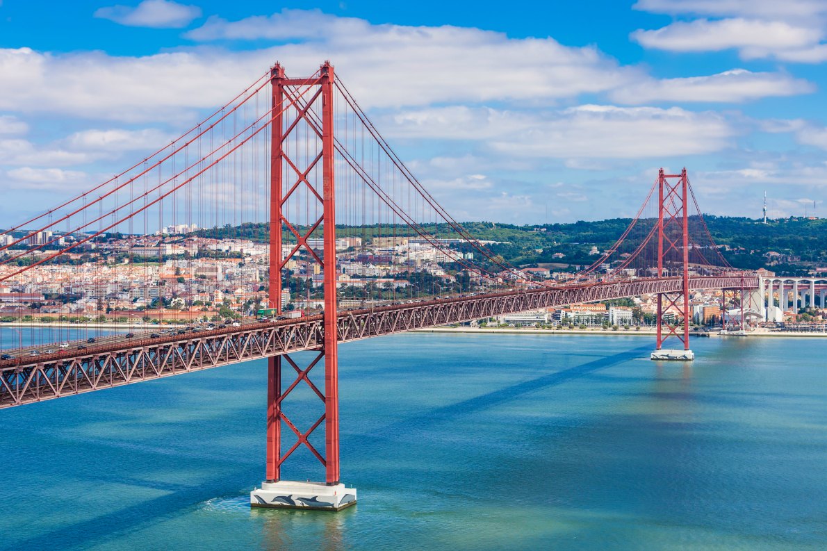 Best destinations to visit by train - Lisbon - The 25 de Abril Bridge is a bridge connecting the city of Lisbon to the municipality of Almada on the left bank of the Tejo river, Lisbon Copyright s - European Best Destinations