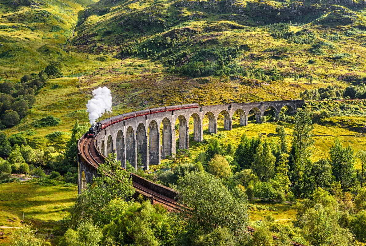 Best destinations to visit by train - Glenfinnan Railway Viaduct in Scotland with the Jacobite steam train passing over Copyright Nick Fox - European Best Destinations