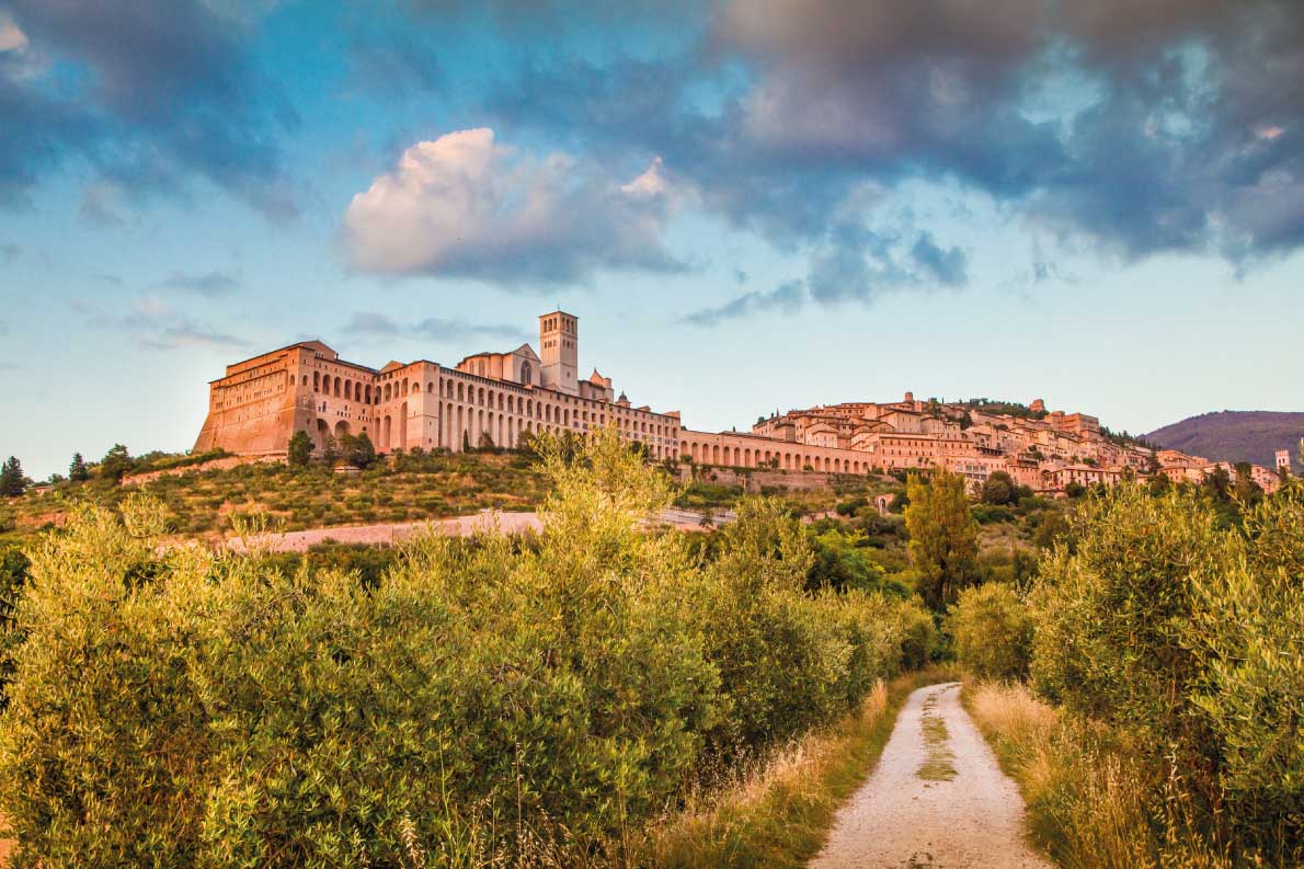 Best fortified destinations in Europe - Beautiful view of the ancient town of Assisi with dramatic cloudscape in golden evening light, Umbria, Italy Copyright Canadastock  - European Best Destinations
